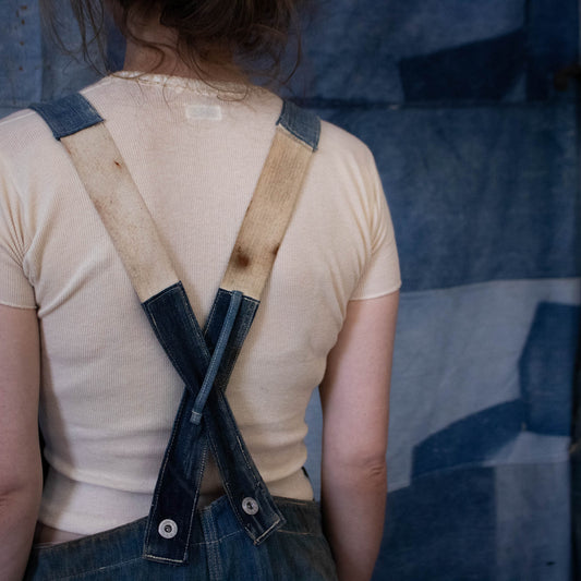 Early 1900s overalls with strap extension.